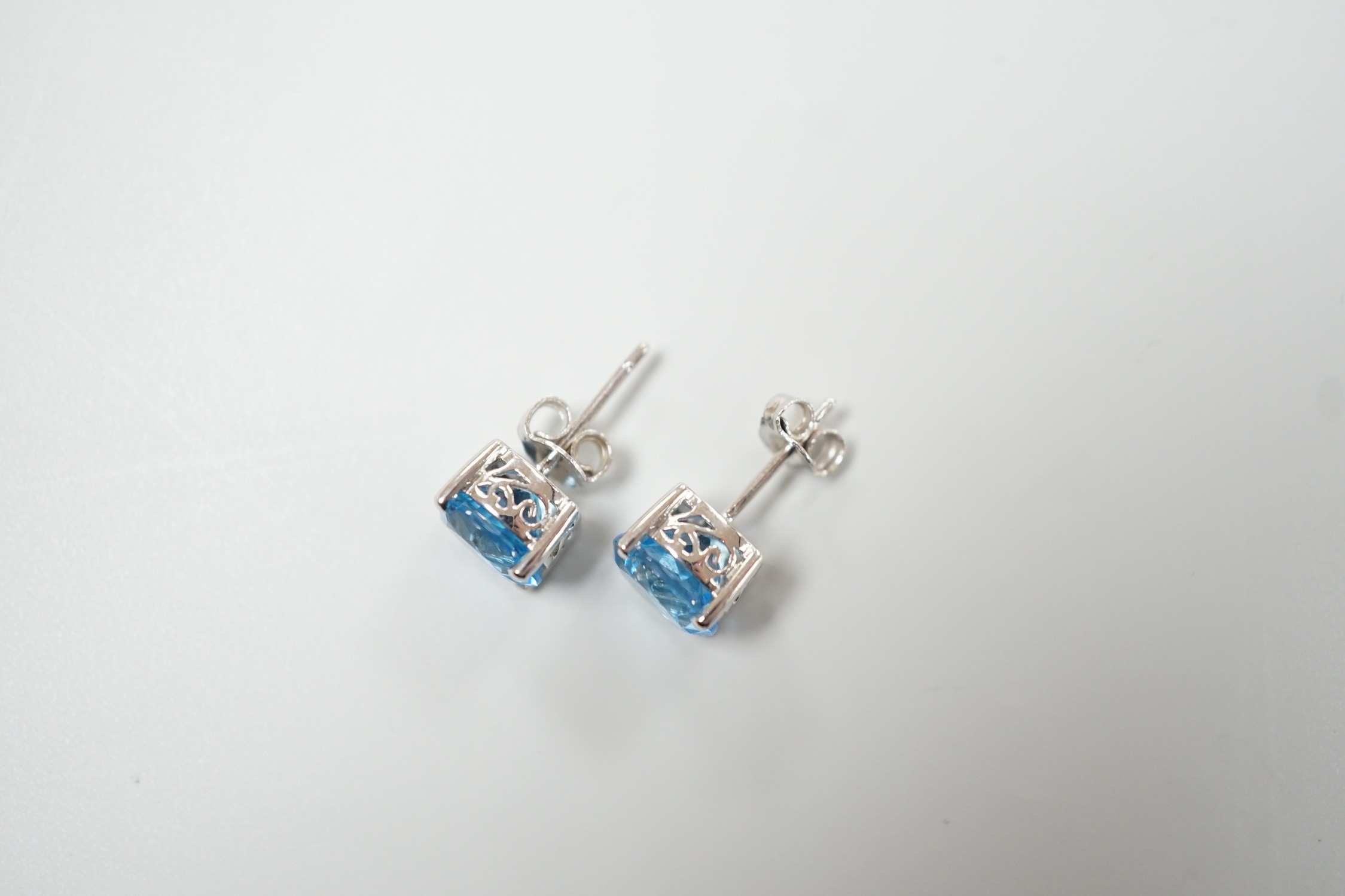 A modern pair of white metal (stamped 18) and single stone blue topaz set ear studs, 7mm, gross weight 3.1 grams.